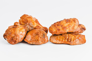 Chicken wings fried until half cooked, semi-finished product with fresh herbs on a white background. Fast food. Fast cooking.Quick cooking at home. Copy space.Fast homemade food.Raw chicken meat.