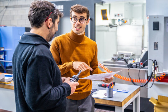 Cnc modern factory workers talking while working