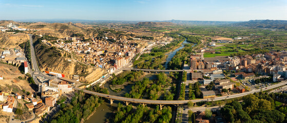 Bird's eye view of Spanish town Fraga. Cinca River visible from above. - obrazy, fototapety, plakaty