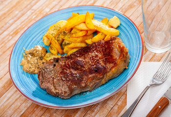 Image of a delicious juicy grilled beef steak and fried potatoes...