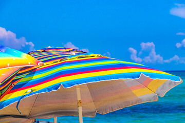 Colorful parasol with many colors on the Caribbean beach in Mexico.