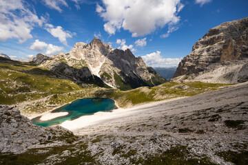 Spectacular scene of small serene natural lakes Bodenseen under summer sun surrounded by greenery and rocky mountains in Sexten Dolomites in South Tyrol, Italy