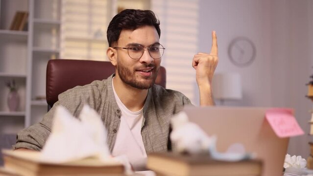 Portrait of young handsome man student or freelancer thinks questioningly and finding solution and typing on laptop computer at home Idea pointing forward index finger concept