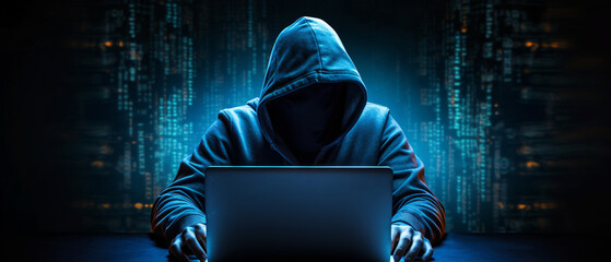 hacker man with his laptop about to hack and commit a cyber crime - obrazy, fototapety, plakaty