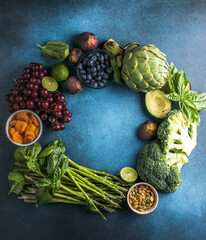 Variety of fresh raw organic fruits and vegetables.  Health foods high in protein vitamins, antioxidants, anthocyanins, fibre.colorful fresh group of vegetables for a balanced diet.