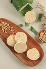 Raw Tempeh or Tempe Mentah, Slices in Wooden Oval Plate.