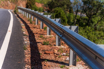 The guard rail, barrier on wayside with cloudy and hill. the straight line from highway fence....