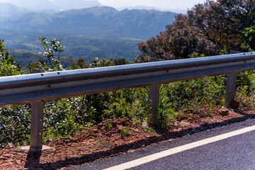 The guard rail, barrier on wayside with cloudy and hill. the straight line from highway fence. image from background, highway fence