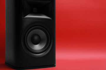 One wooden sound speaker on red background, closeup. Space for text