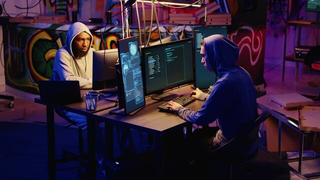 Hackers rushing to leave underground base after hearing police sirens while pirating software. Rogue programmers running to escape law enforcement coming to arrest them for cracking videogames