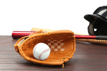 Baseball glove, bats, ball and batting helmet on wooden table against white background