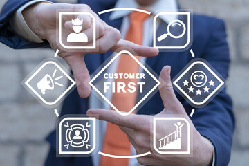 Businessman using virtual interface sees inscription: CUSTOMER FIRST. Client centricity business...