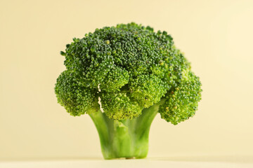 Fresh raw broccoli on beige background, closeup