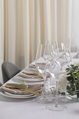 Beautiful table setting with floral decor indoors