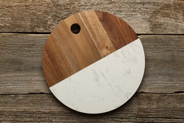 One new cutting board on old wooden table, top view