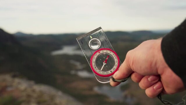 Hiker Holding A Compass To Find Direction. - close up shot