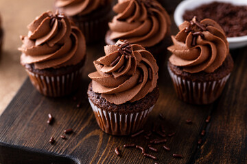 Dark chocolate cupcakes with chocolate ganache frosting - obrazy, fototapety, plakaty