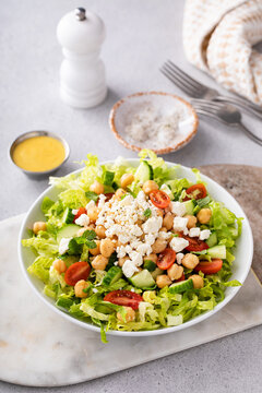Healthy salad for lunch with fresh vegetables, chickpeas and feta