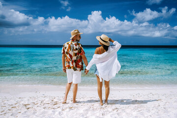 Playa Porto Marie beach Curacao, a white tropical beach with turqouse water in ocean Caribbean sea, a couple of men and women on vacation in Curacao © Fokke Baarssen