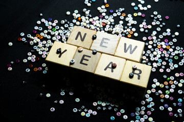 New year resolutions with writing block with a collection of letters in the background