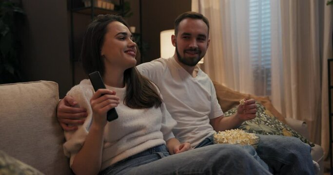 Two people sitting in living room, dancing, listening to music, and singing along to their favorite songs siblings friends romantic couple, but in moment, enjoying each other's company and music.