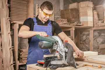 Carpenter cutting oriented strand board with circular saw in workshop. Close-up of carpenter...