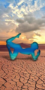 Video of blue yoga posture in the middle of the desert, in orange tones, with moving clouds. Ideal for topics such as the environment and the relationship between human beings and their environment.