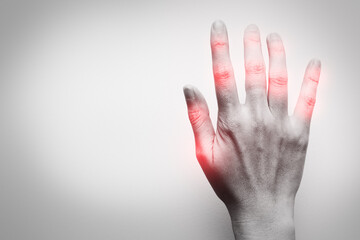 Hand of woman on white background  with red spot on finger joint. Pain problem