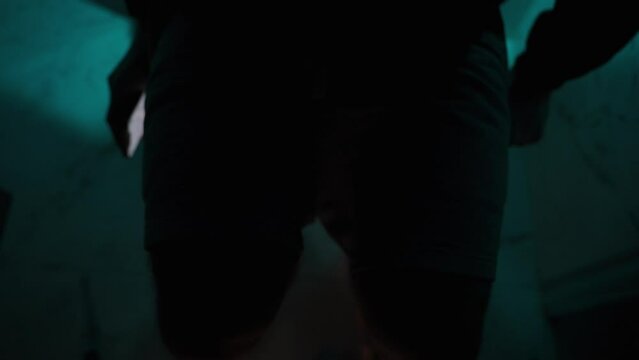 Night, Under Dim Blue Light, a Man Sits on the Toilet and Begins to Browse Something on His Phone, Scrolling. Utilize the White Screen for Copy Space.
