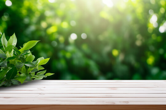 Empty old white wooden table or counter with a background of green leaves, ideal for displaying or montage of your products. Bright image. 