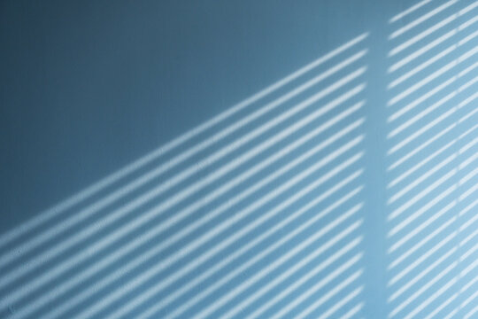 light and shadow of blind form the window on the concrete wall
