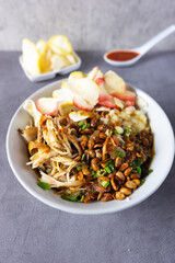 Bubur ayam or Chicken Porridge, Indonesian traditional food consist of white rice porridge, shredded chicken, fried soybean, crackers, leek.
