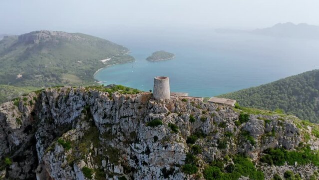 Old ruined tower on the tip of an island Mountain landscape surrounded by a blue ocean