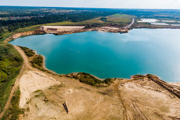 Fototapeta premium A flooded sand pit with turquoise water. View from high altitude