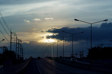 Fototapeta na wymiar Road bridges and light pole on sunset sky scenery. silhouette.