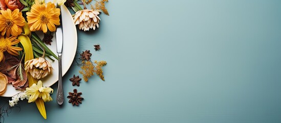 Stylish table arrangement with utensils, napkin, flower, and space for text.
