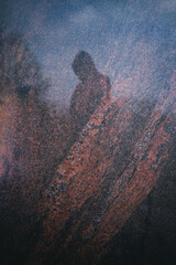 human silhouette in perfectly polished mirror smooth colorful rare species granite surface