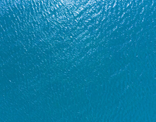 Aerial view of a crystal clear sea water texture. View from above Natural blue background. Blue...