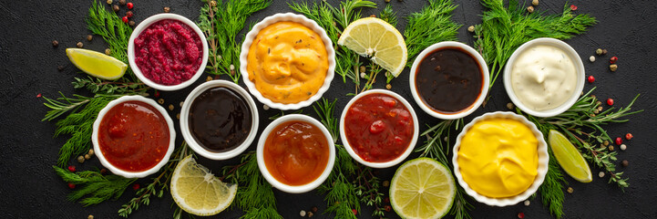 Different types of sauces in bowls with seasonings banner, rosemary and dill, thyme and and...