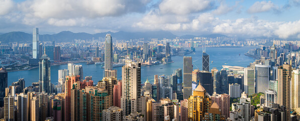 Panoramic view of Hong Kong City  in cloudy day and good weather. View of financial district high-rise and residential buildings from Victoria Peak Observation Deck. - obrazy, fototapety, plakaty