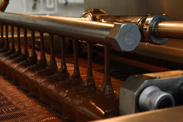 Chocolate pours from the machine at the factory.