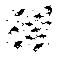 silhouette of a collection of black fish swimming