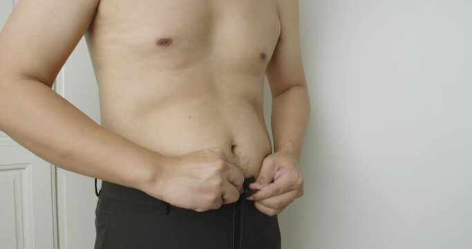 Asian fat man with excess belly fat, Unhealthy lifestyle, Diet concept.
