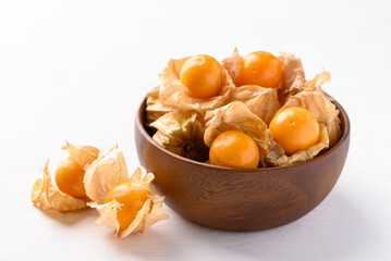 Cape gooseberry, Goldenberry or Physalis peruviana in wooden bowl on white background