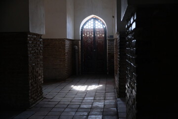 A corridor with shuttered doors. Mausoleum of Khoja Ahmed Yasawi. Historical complex, UNESCO World...