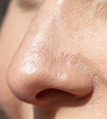 Fototapeta premium Close-up of a woman's nose. Macro