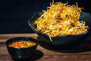 Tasty golden fried papaya served with sweet and sour Som Tum sauce