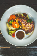 Succulent 300gm bone in pork chop served with mashed potatoes, buttered vegetables and finished with homemade LP sauce