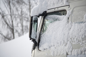 White truck partially buried under the snow