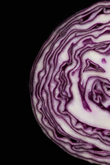 Top view of red cabbage slice with abstract lines on black background